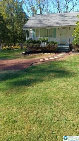 a front view of a house with a yard and porch