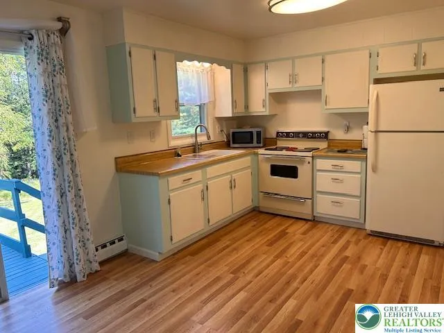 a kitchen with a stove a sink and a refrigerator