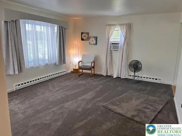 a living room with a couch and floor to ceiling window