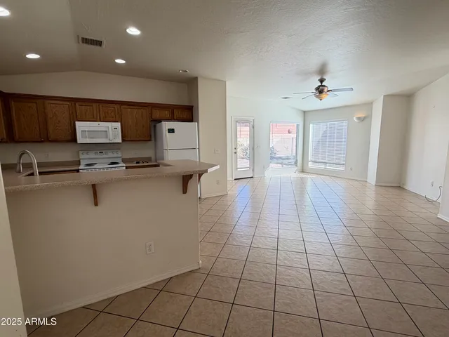 a kitchen with stainless steel appliances a sink a stove a microwave and cabinets