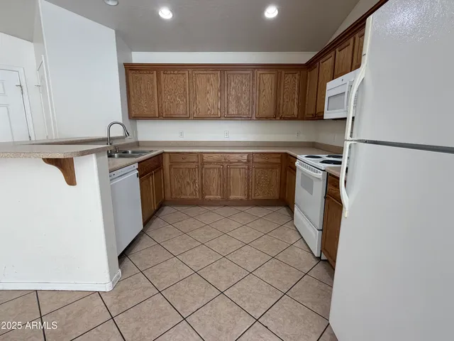 a kitchen with stainless steel appliances granite countertop a refrigerator sink and cabinets