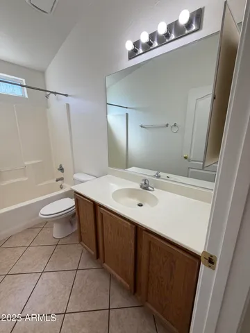 a bathroom with a sink a toilet a mirror and shower
