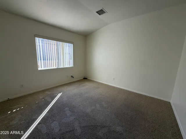 an empty room with a empty space and windows