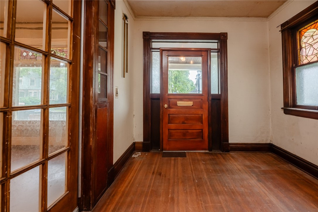 82 Harper Street Rochester, NY 14607 - Photo 11 of 46 Gumwood surrounds you in the foyer.