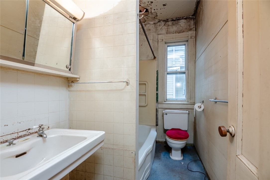 82 Harper Street Rochester, NY 14607 - Photo 37 of 46 A convenient first floor full bath off the kitchen