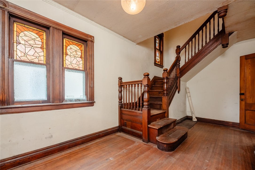82 Harper Street Rochester, NY 14607 - Photo 7 of 46 The front foyer captures a by-gone area with the o