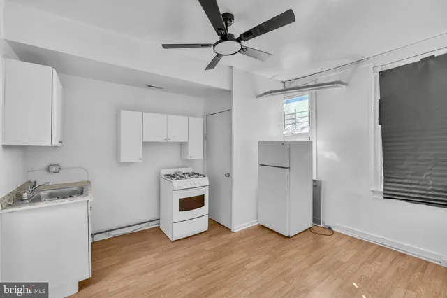 a view of a kitchen with a sink cabinets and wooden floor