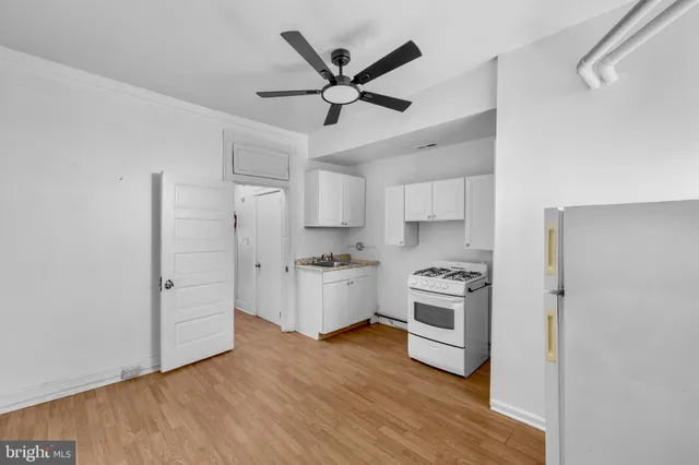 a kitchen with white cabinets and stainless steel appliances