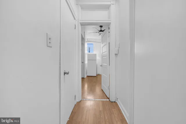 a view of a hallway with wooden floor