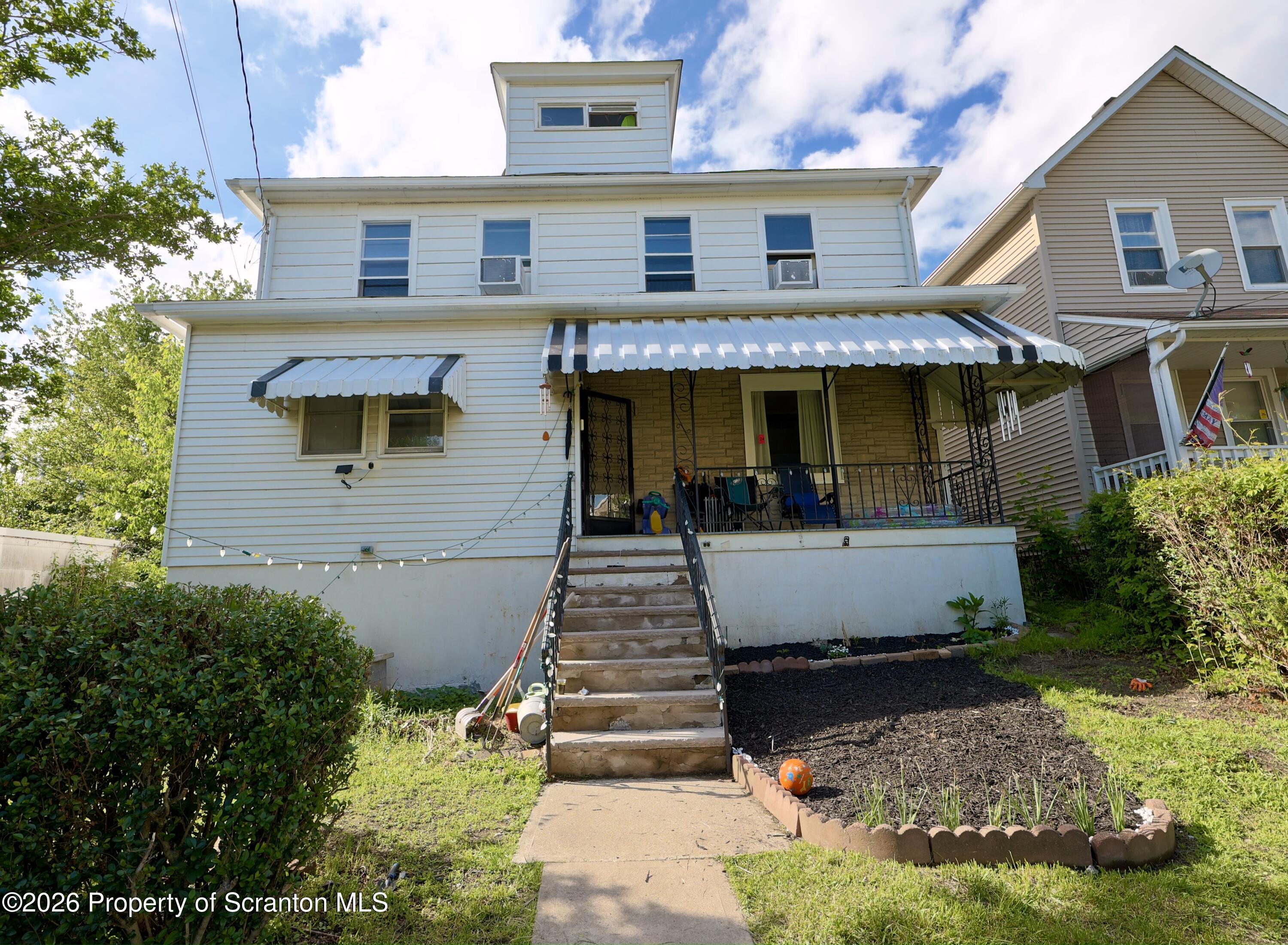 827 Main Street Sugar Notch, PA 18706 - Photo 1 of 25 a front view of a house with a yard