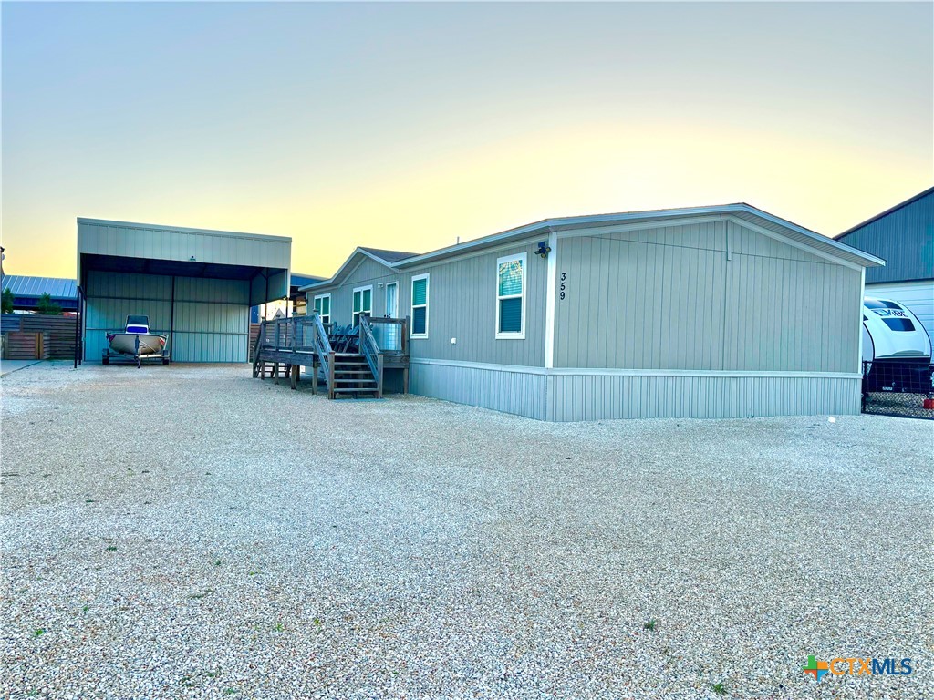 359 Byers Street Port O'Connor, TX 77982 - Photo 1 of 45 a view of a house with a yard and sitting area
