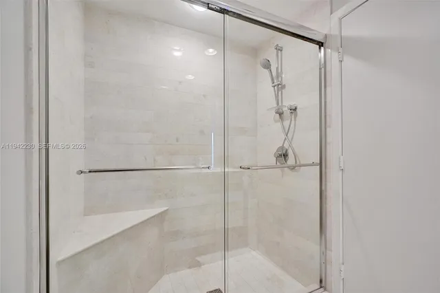 a bathroom with a glass shower door
