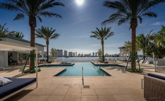 a swimming pool with outdoor seating