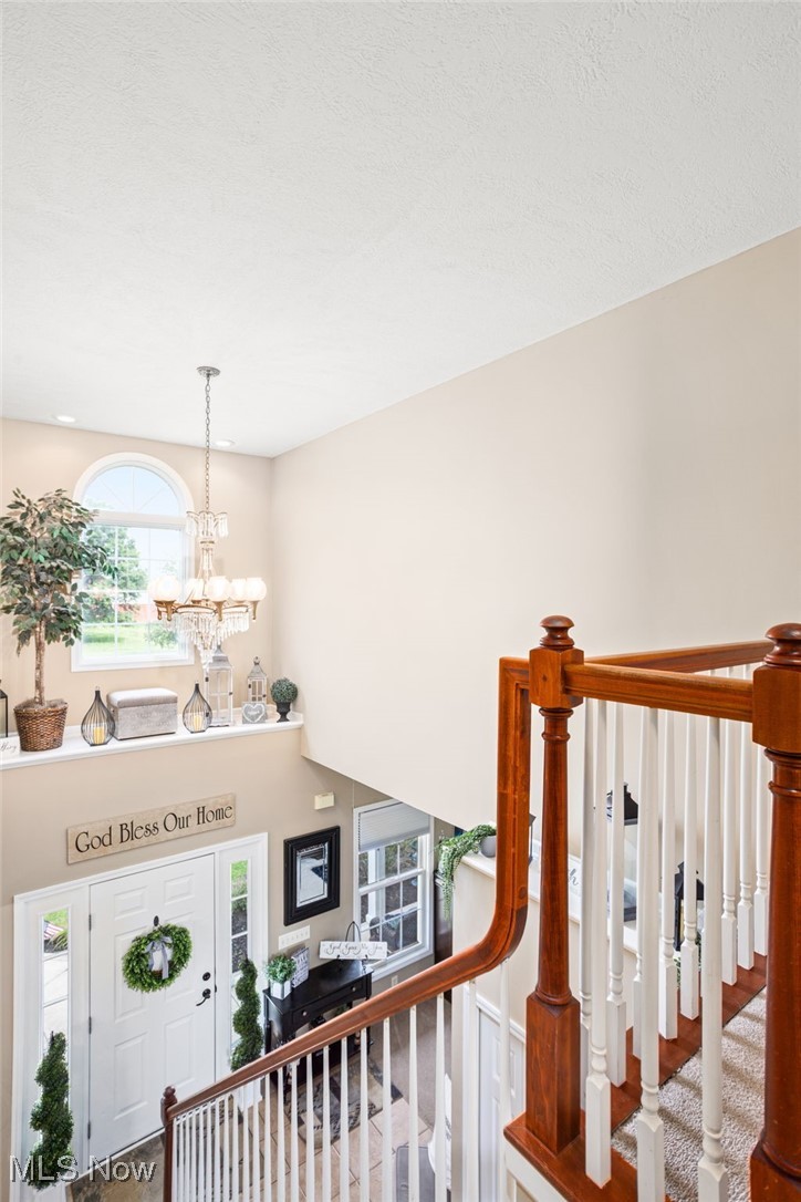 11620 Friendsville Road Creston, OH 44217 - Photo 23 of 40 Foyer with a chandelier, a high ceiling, and a textured ceiling