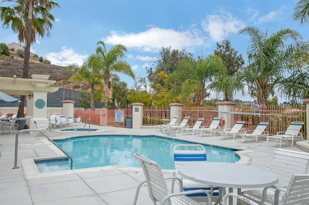 10472 Celestial Waters Drive Spring Valley, CA 91977 - Photo 22 of 24 a view of a patio with dining table and chairs with wooden floor and fence