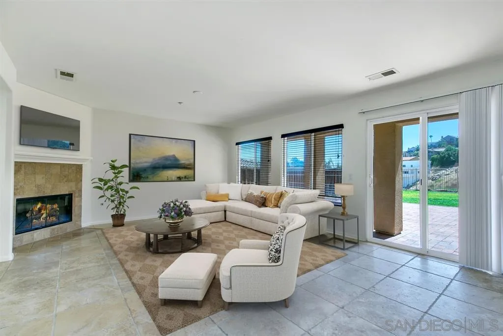 10472 Celestial Waters Drive Spring Valley, CA 91977 - Photo 7 of 24 a living room with furniture large window and a fireplace