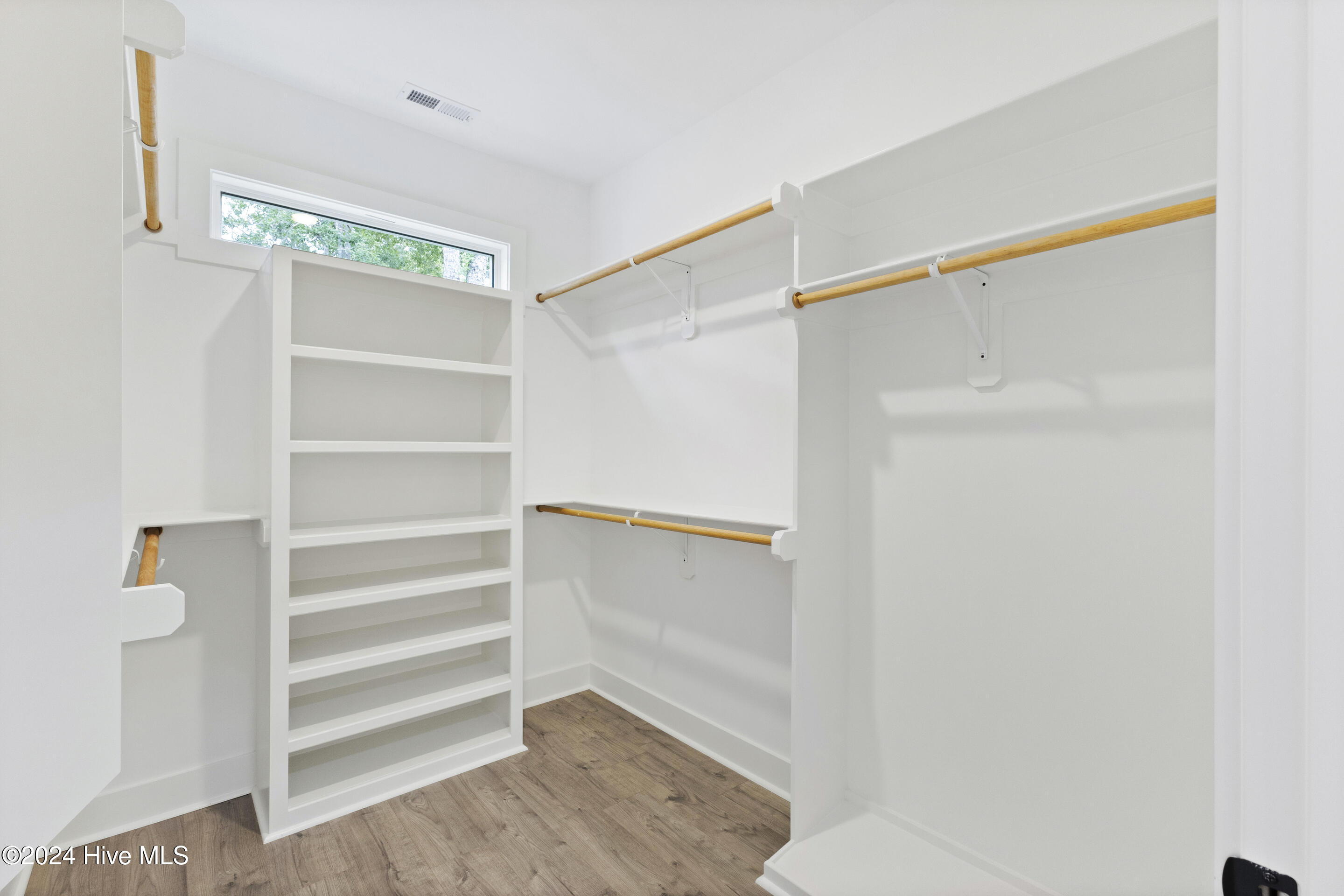 1656 Winding Way Southwest Ocean Isle Beach, NC 28469 - Photo 22 of 49 Primary closet with wood shelving