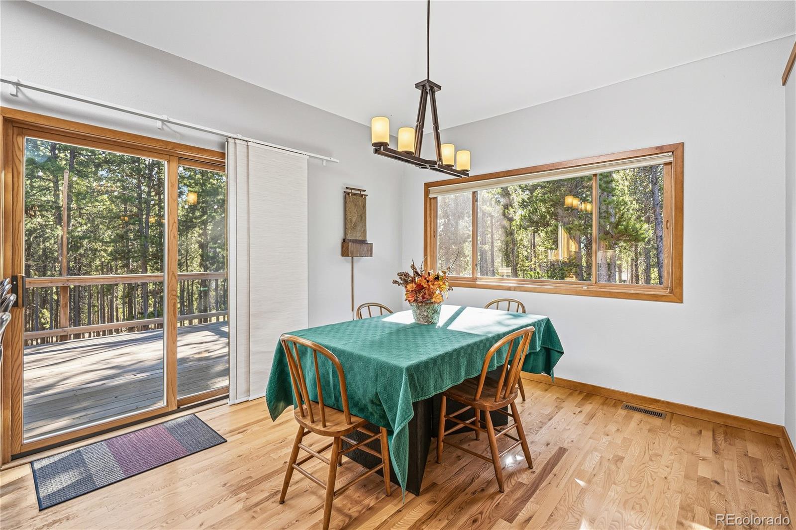 9274 Sandy Lane Conifer, CO 80433 - Photo 15 of 48 a view of a dining room with furniture window and outside view