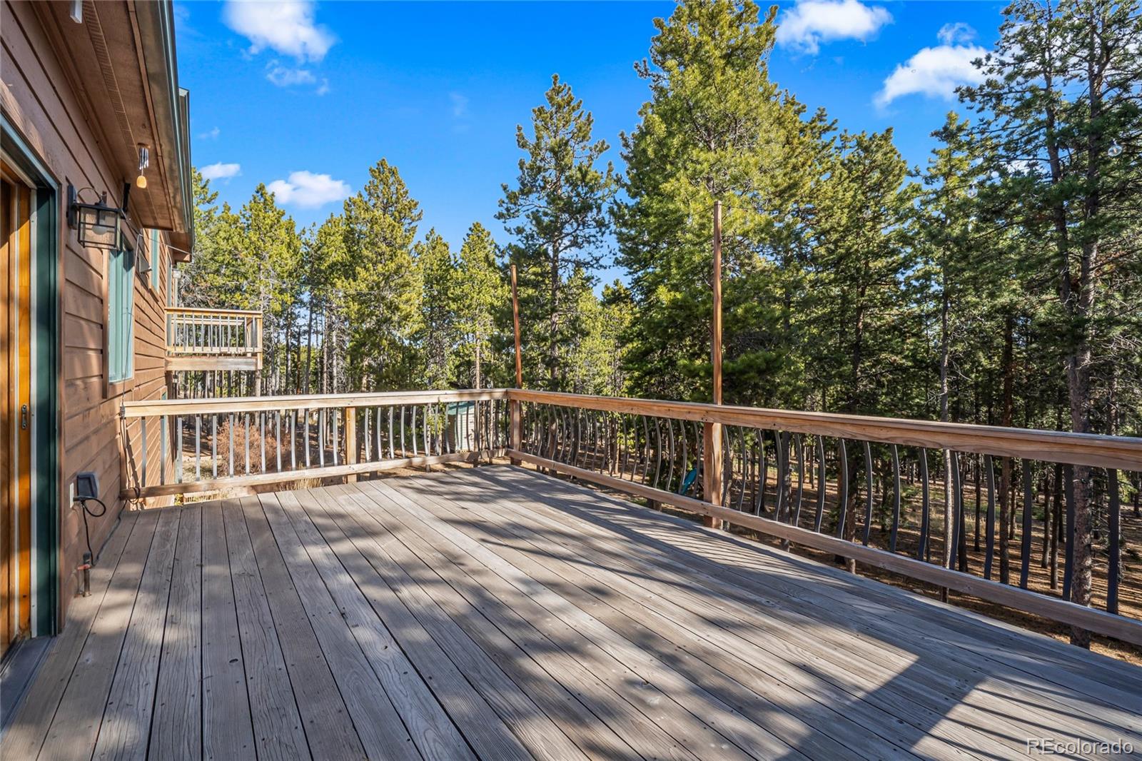 9274 Sandy Lane Conifer, CO 80433 - Photo 18 of 48 a view of a balcony with wooden floor