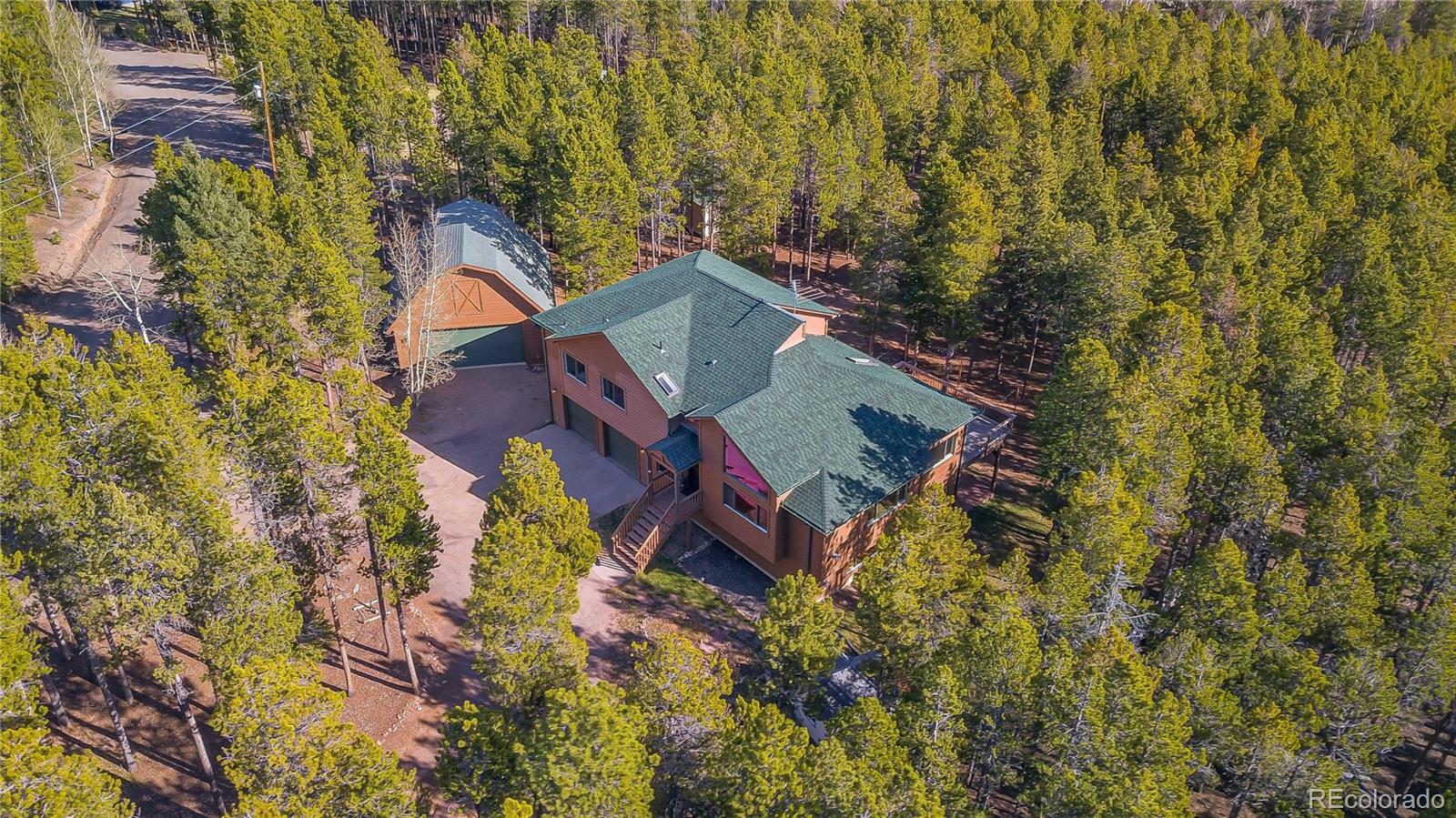 9274 Sandy Lane Conifer, CO 80433 - Photo 2 of 48 view of a house with a yard