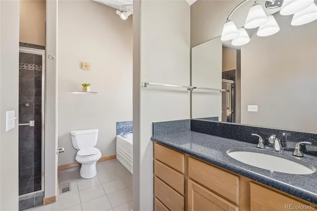 a bathroom with a granite countertop sink a toilet and a mirror