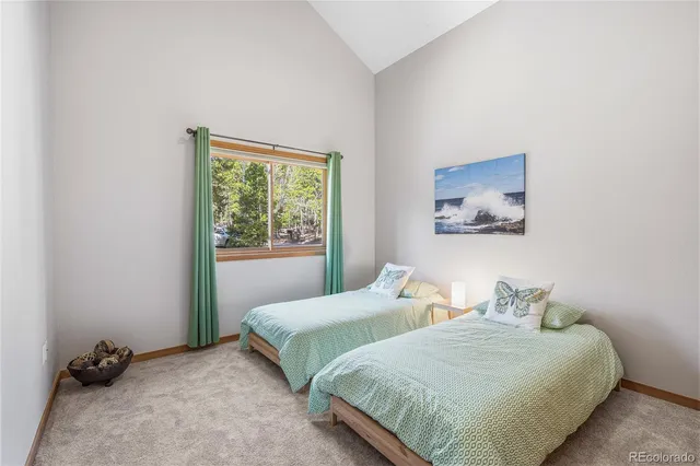 a bedroom with two beds and a window