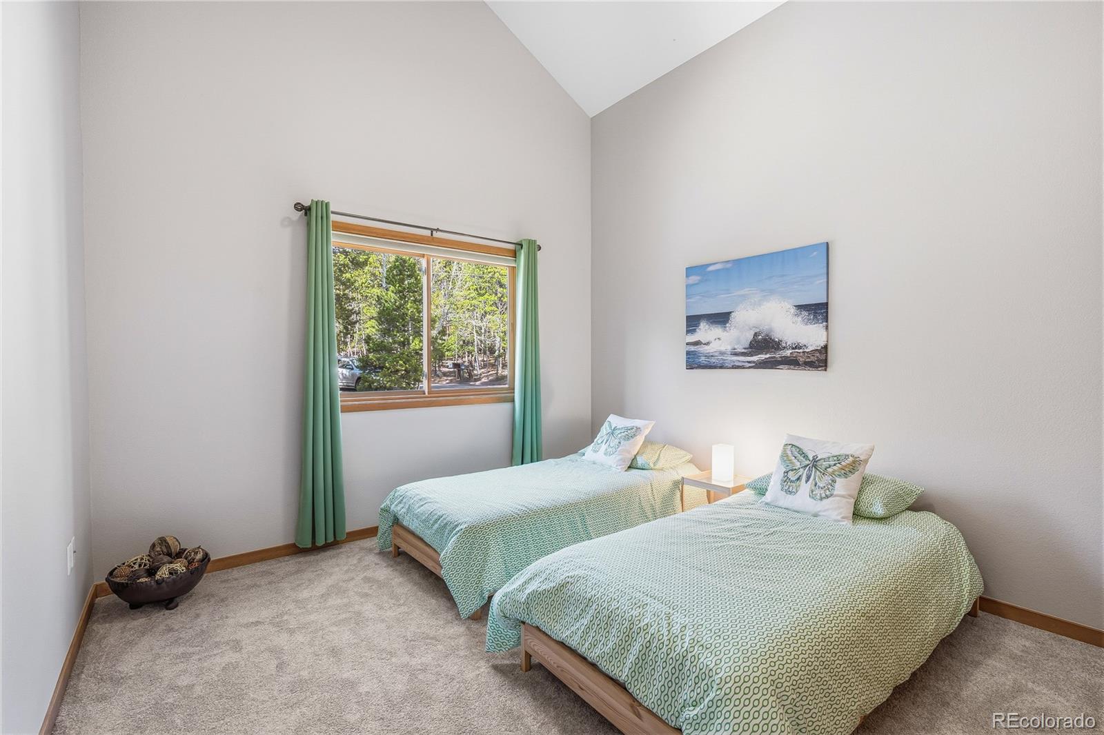 9274 Sandy Lane Conifer, CO 80433 - Photo 28 of 48 a bedroom with two beds and a window