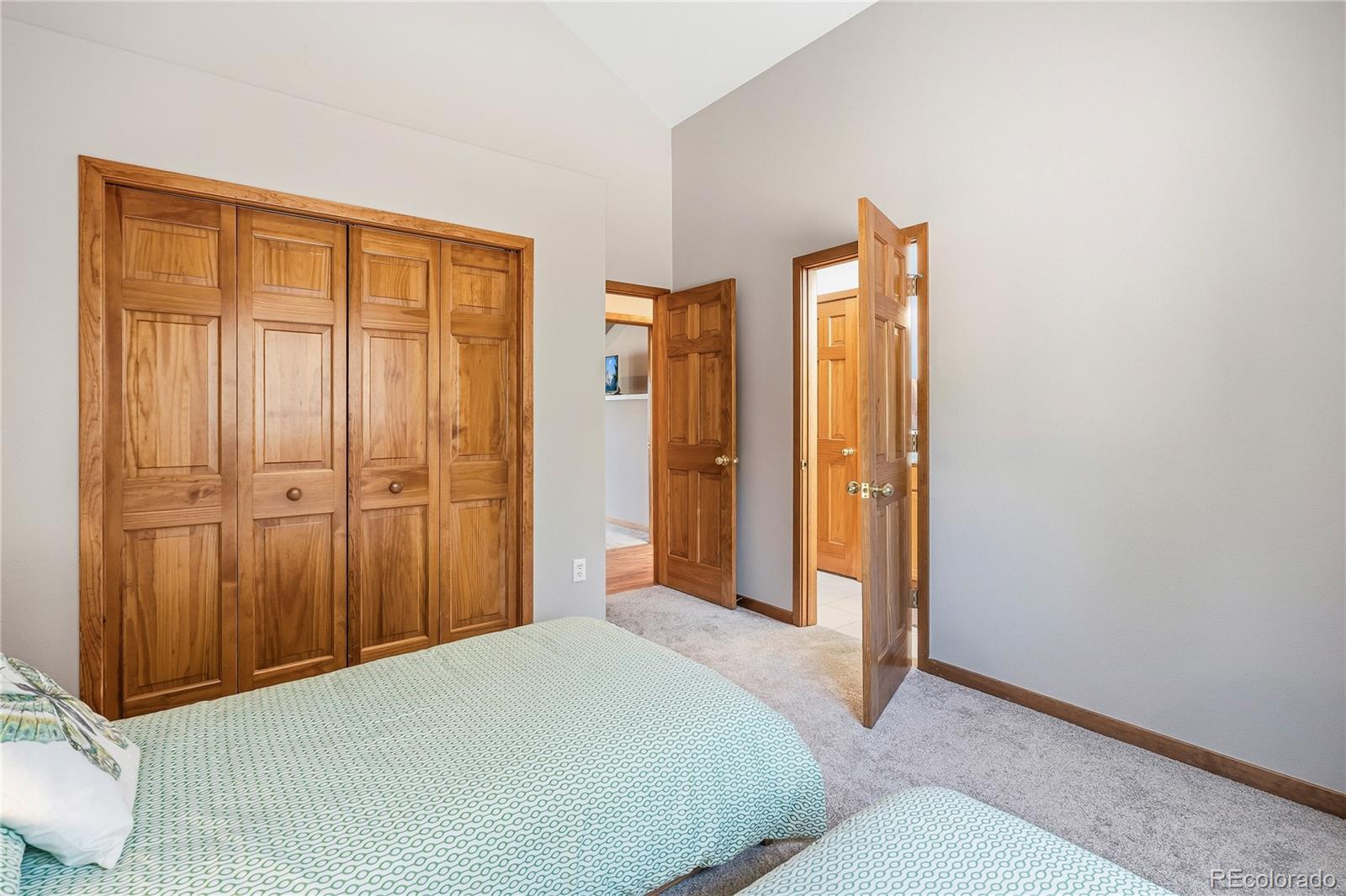 9274 Sandy Lane Conifer, CO 80433 - Photo 29 of 48 a bedroom with a bed and a dresser