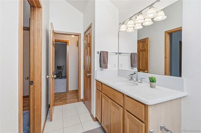 a bathroom with a sink vanity and a mirror