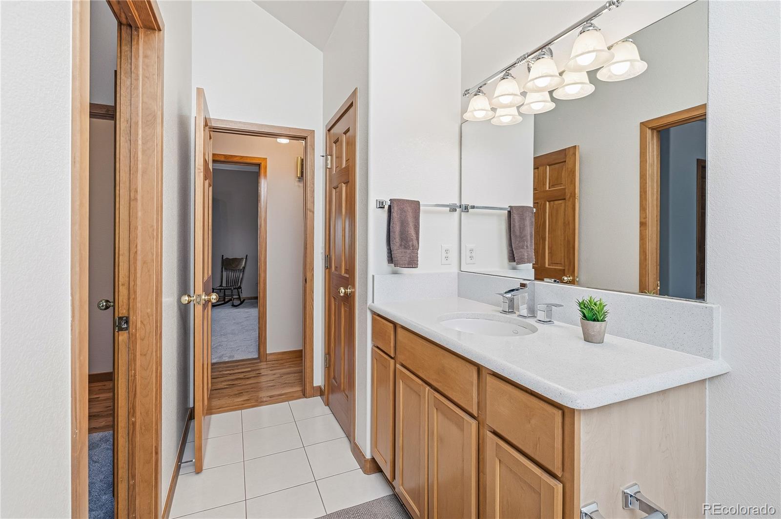 9274 Sandy Lane Conifer, CO 80433 - Photo 34 of 48 a bathroom with a sink vanity and a mirror