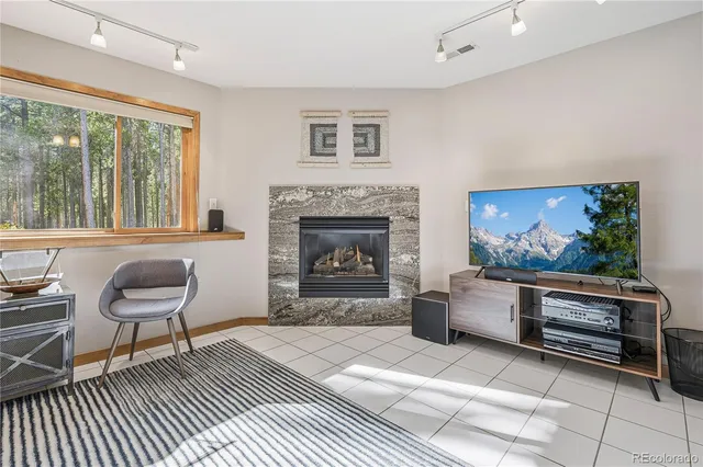 a living room with furniture a window and a fireplace