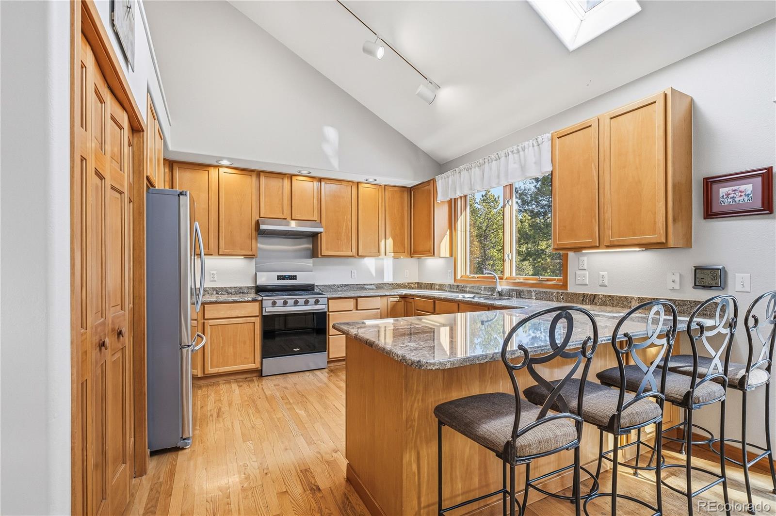 9274 Sandy Lane Conifer, CO 80433 - Photo 8 of 48 a kitchen with stainless steel appliances granite countertop sink stove refrigerator and cabinets