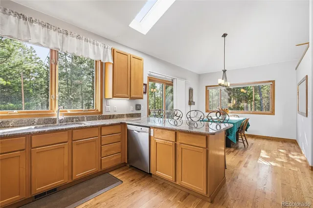 a kitchen with sink a window and dining table