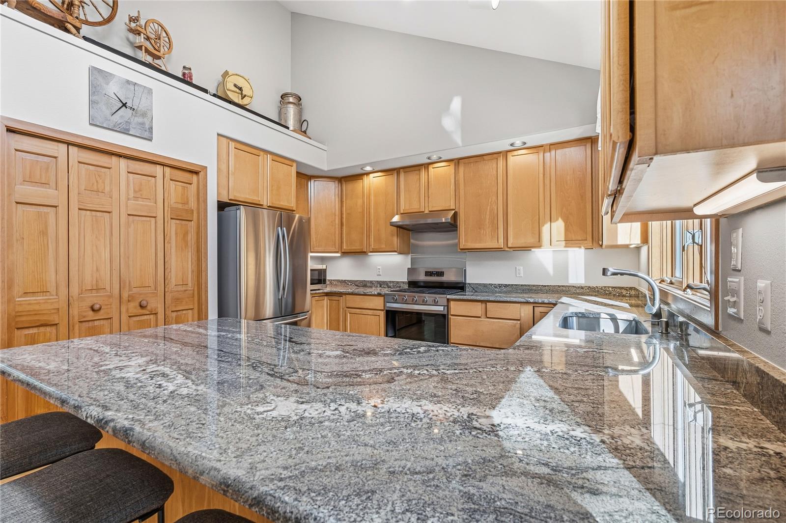 9274 Sandy Lane Conifer, CO 80433 - Photo 10 of 48 a kitchen with stainless steel appliances granite countertop a sink a stove counter space and a window