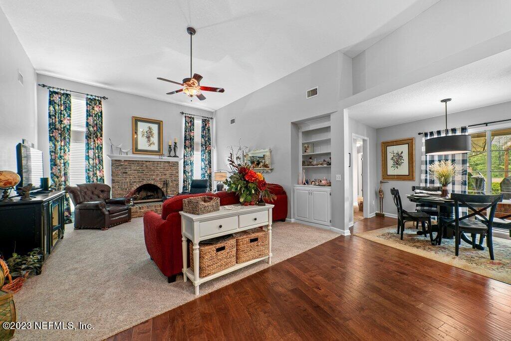 10079 Pebble Ridge Drive North Jacksonville, FL 32220 - Photo 12 of 32 a living room with furniture a fireplace and a flat screen tv