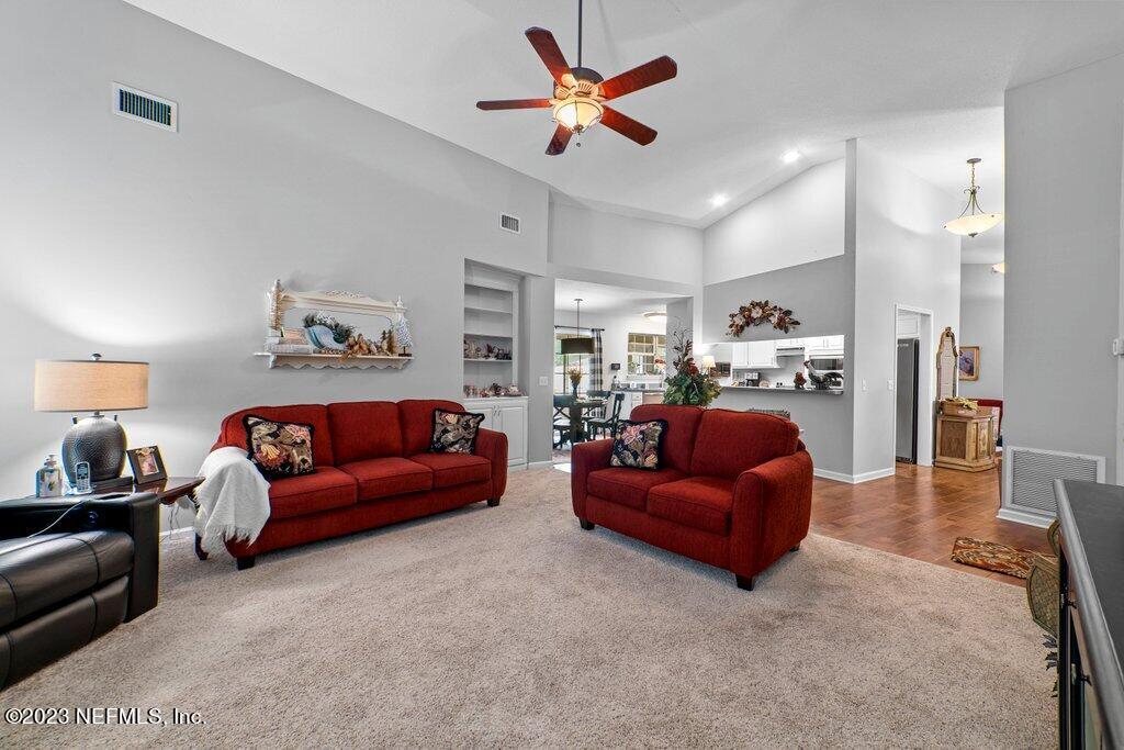 10079 Pebble Ridge Drive North Jacksonville, FL 32220 - Photo 13 of 32 a living room with furniture and a chandelier