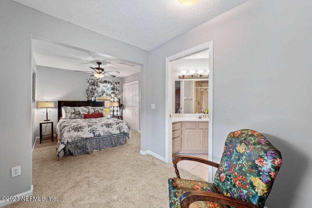 10079 Pebble Ridge Drive North Jacksonville, FL 32220 - Photo 14 of 32 a bedroom with a bed and furniture