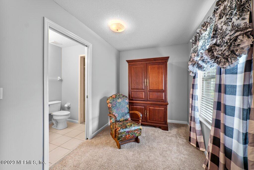 10079 Pebble Ridge Drive North Jacksonville, FL 32220 - Photo 16 of 32 a living room with furniture and a toilet