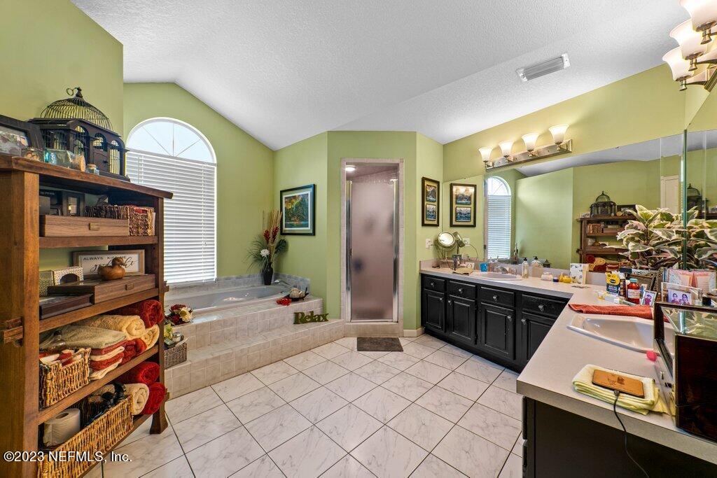 10079 Pebble Ridge Drive North Jacksonville, FL 32220 - Photo 21 of 32 a large spacious bathroom with a double vanity sink and a mirror