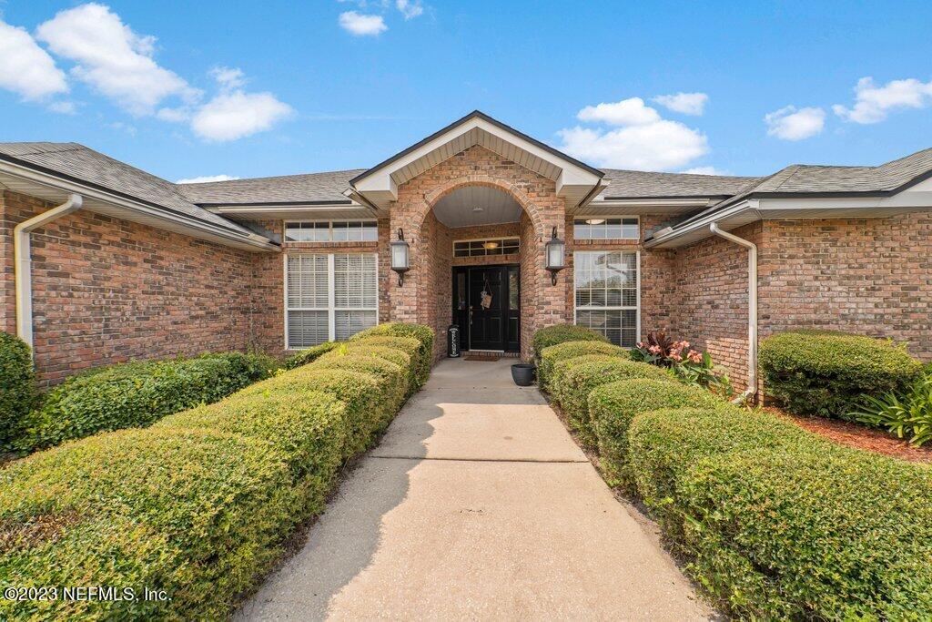 10079 Pebble Ridge Drive North Jacksonville, FL 32220 - Photo 3 of 32 a front view of a house with a garden