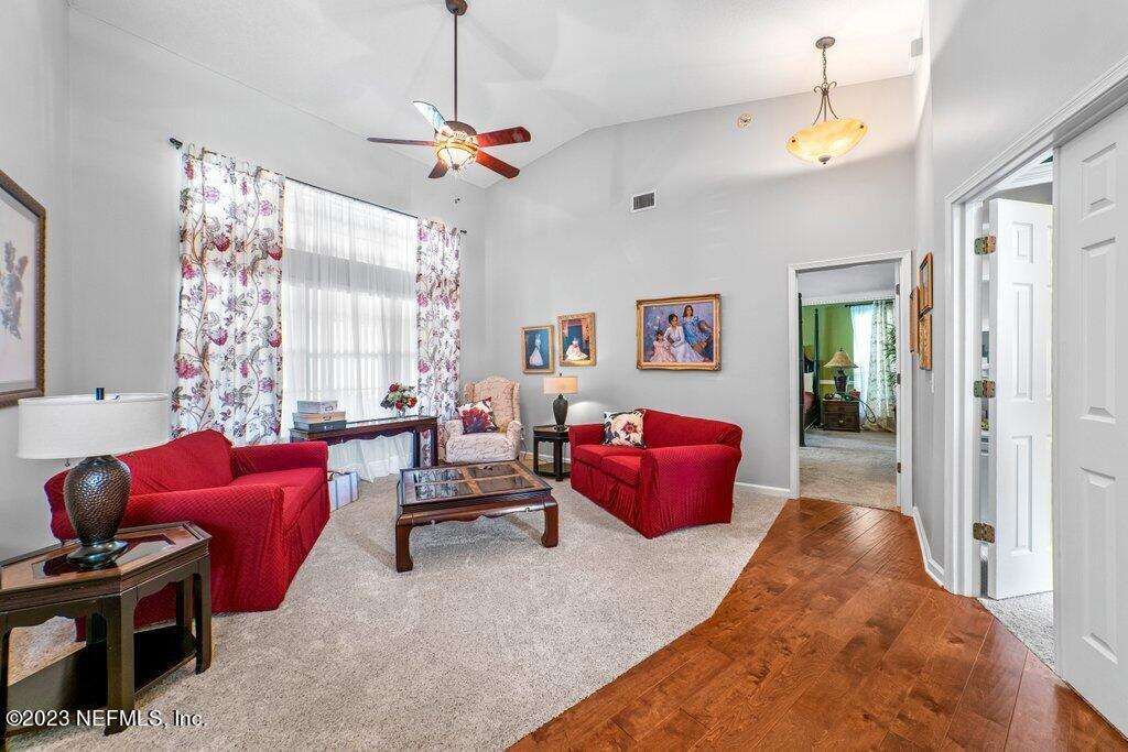 10079 Pebble Ridge Drive North Jacksonville, FL 32220 - Photo 5 of 32 a living room with furniture a window and a chandelier