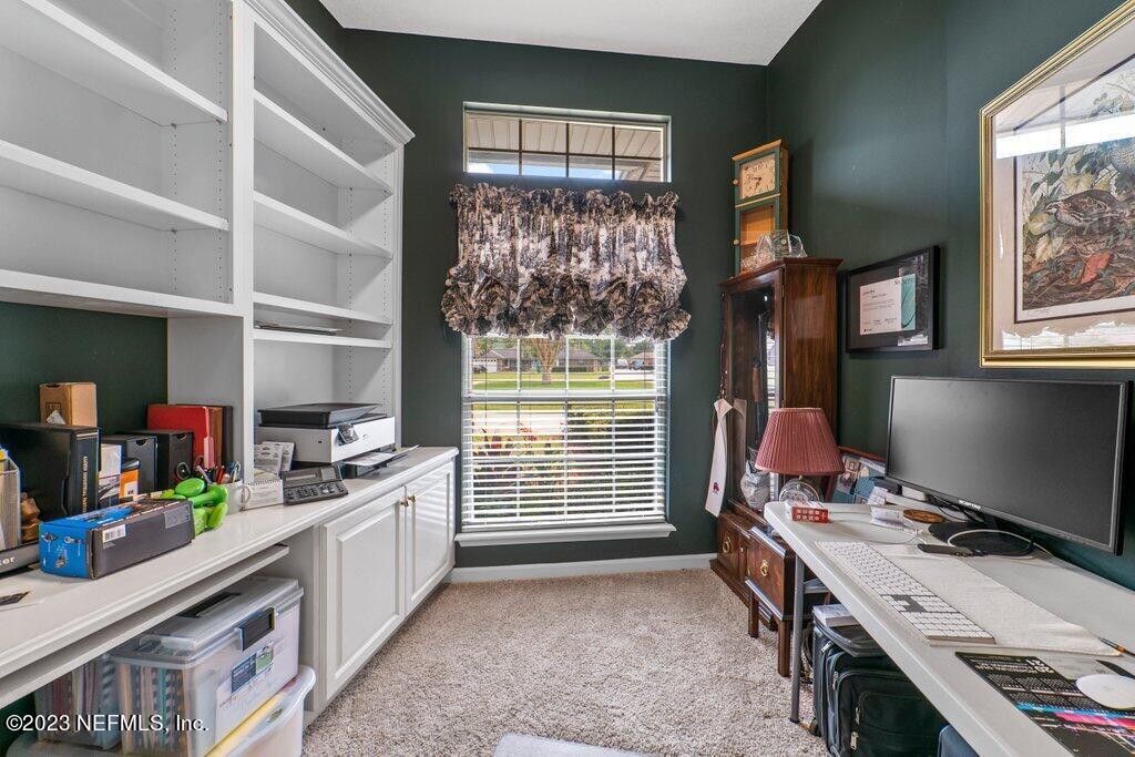 10079 Pebble Ridge Drive North Jacksonville, FL 32220 - Photo 6 of 32 a kitchen that has a lot of cabinets in it