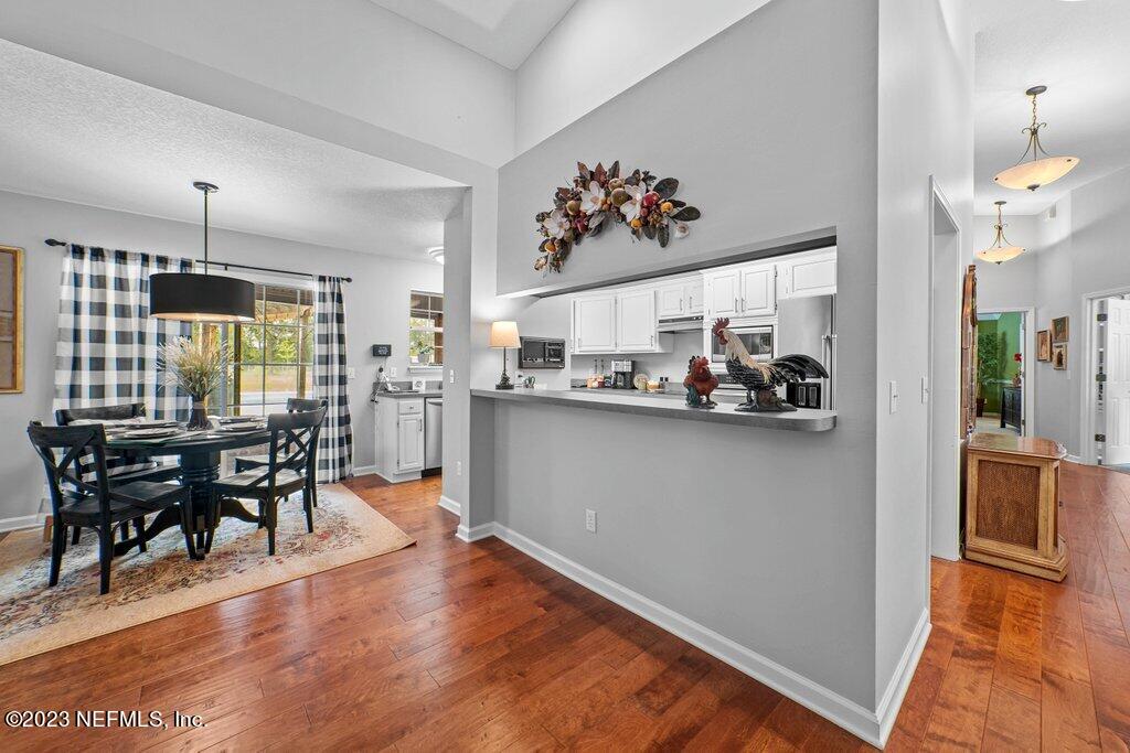 10079 Pebble Ridge Drive North Jacksonville, FL 32220 - Photo 7 of 32 a view of a dining room with furniture window and wooden floor