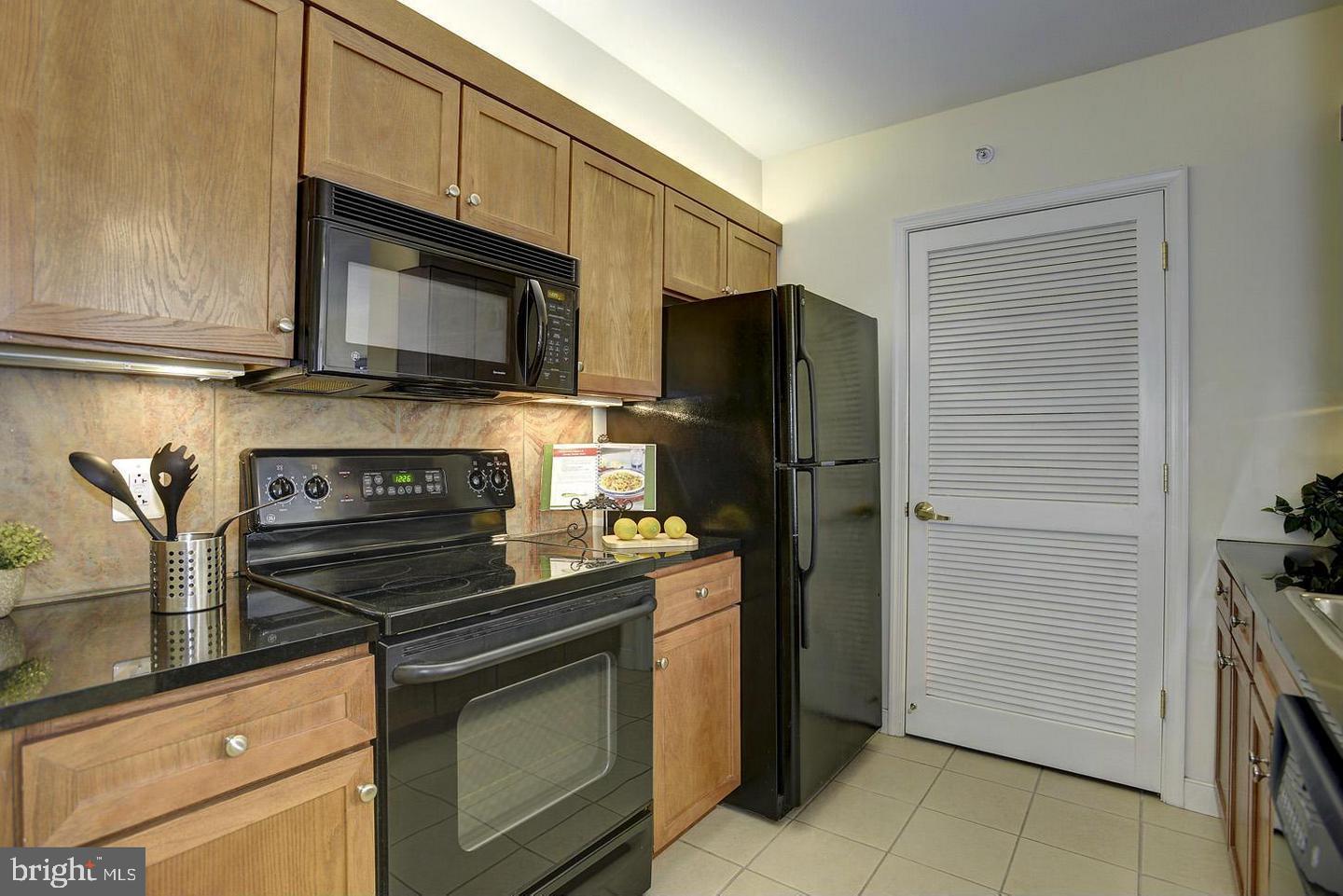 631 D Street Northwest, Unit 626 Washington, DC 20004 - Photo 7 of 19 a kitchen with a refrigerator stove and cabinets