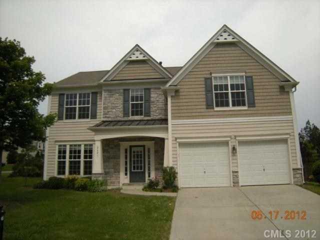 2401 Coltsgate Road, Unit 80 Waxhaw, NC 28173 - Photo 1 of 16 a front view of a house with a yard and trees