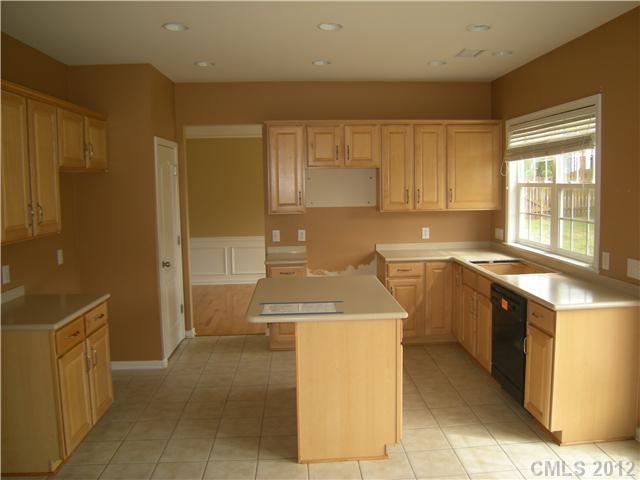 2401 Coltsgate Road, Unit 80 Waxhaw, NC 28173 - Photo 2 of 16 a kitchen with a stove top oven sink and cabinets
