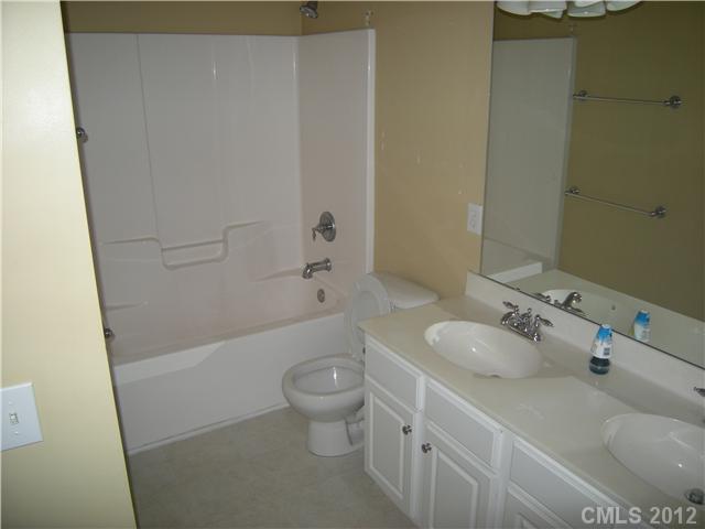 2401 Coltsgate Road, Unit 80 Waxhaw, NC 28173 - Photo 12 of 16 a bathroom with a sink and a mirror