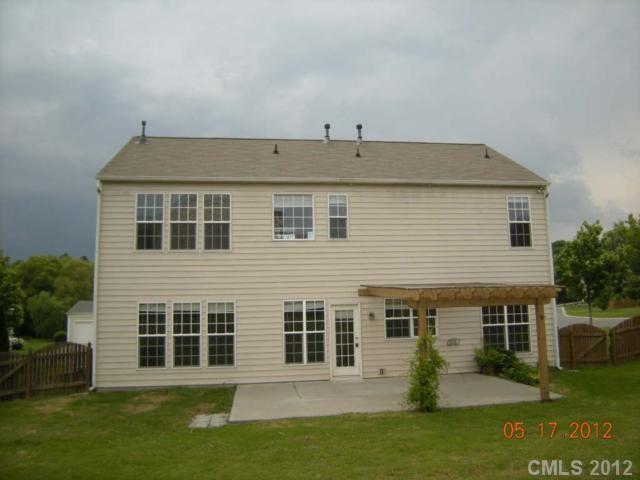 2401 Coltsgate Road, Unit 80 Waxhaw, NC 28173 - Photo 14 of 16 a view of a house with a yard