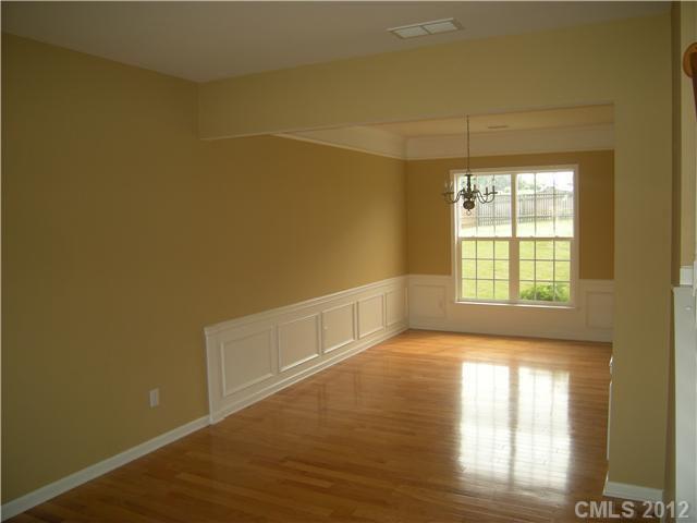 2401 Coltsgate Road, Unit 80 Waxhaw, NC 28173 - Photo 4 of 16 a view of an empty room with wooden floor and a window