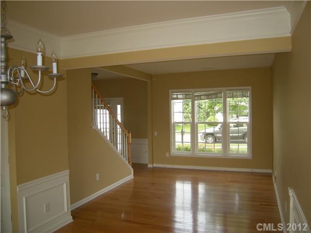 2401 Coltsgate Road, Unit 80 Waxhaw, NC 28173 - Photo 5 of 16 a view of a livingroom with wooden floor and windows
